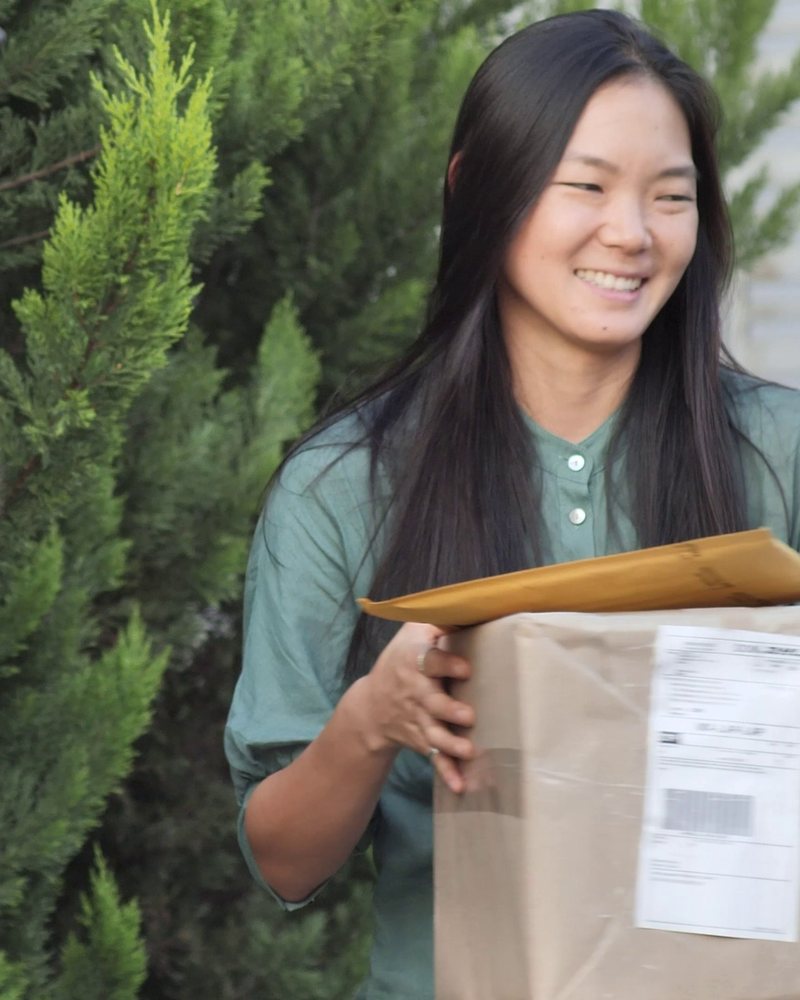 Customer holding the parcel she has just received