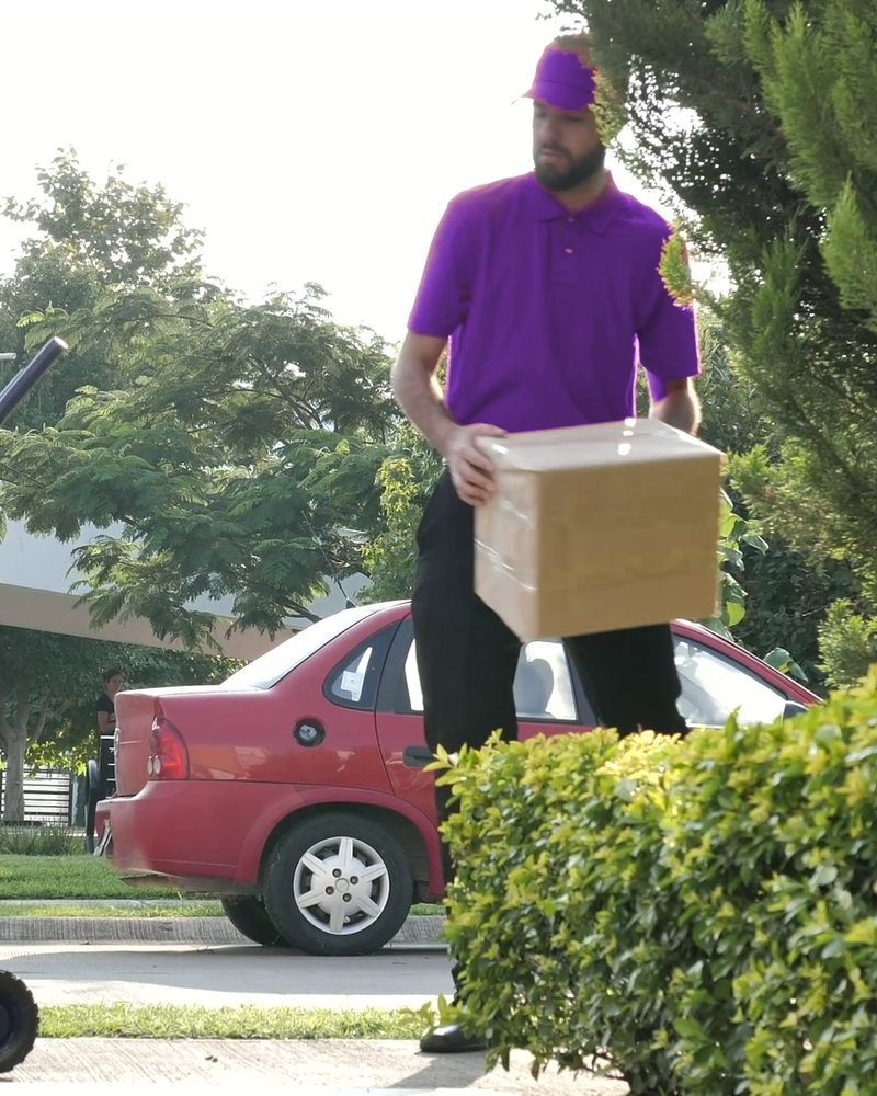Courier wheeling parcels to a delivery