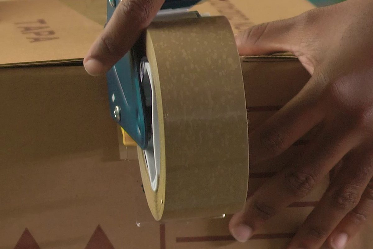 Taping a cardboard box shut
